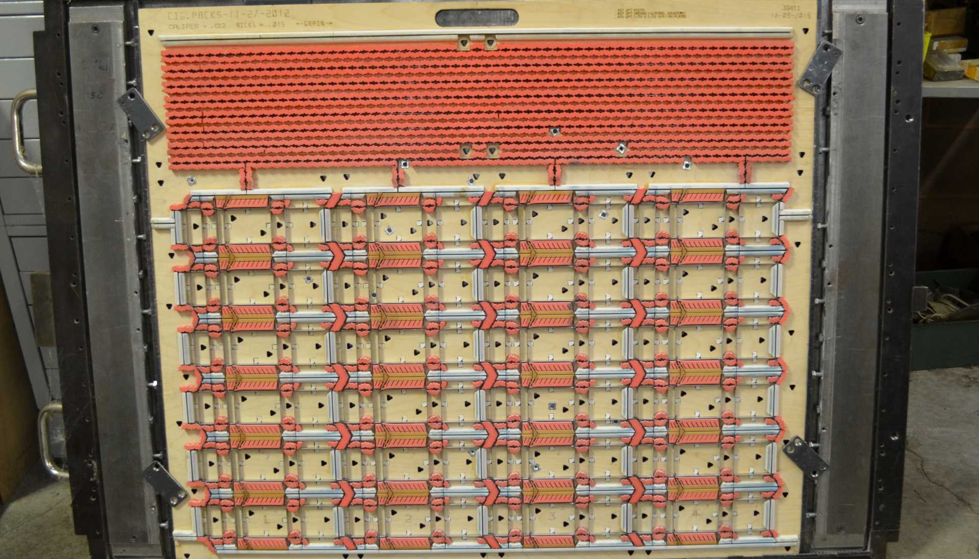 39211 Cigarette Pack Die. This complex steel rule die has many intricate parts. It has been used in production since 2012 and has performed hundreds of thousands of hits.